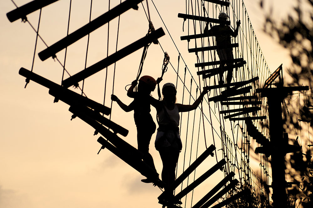Silhouettes of Guests On Ropes Course