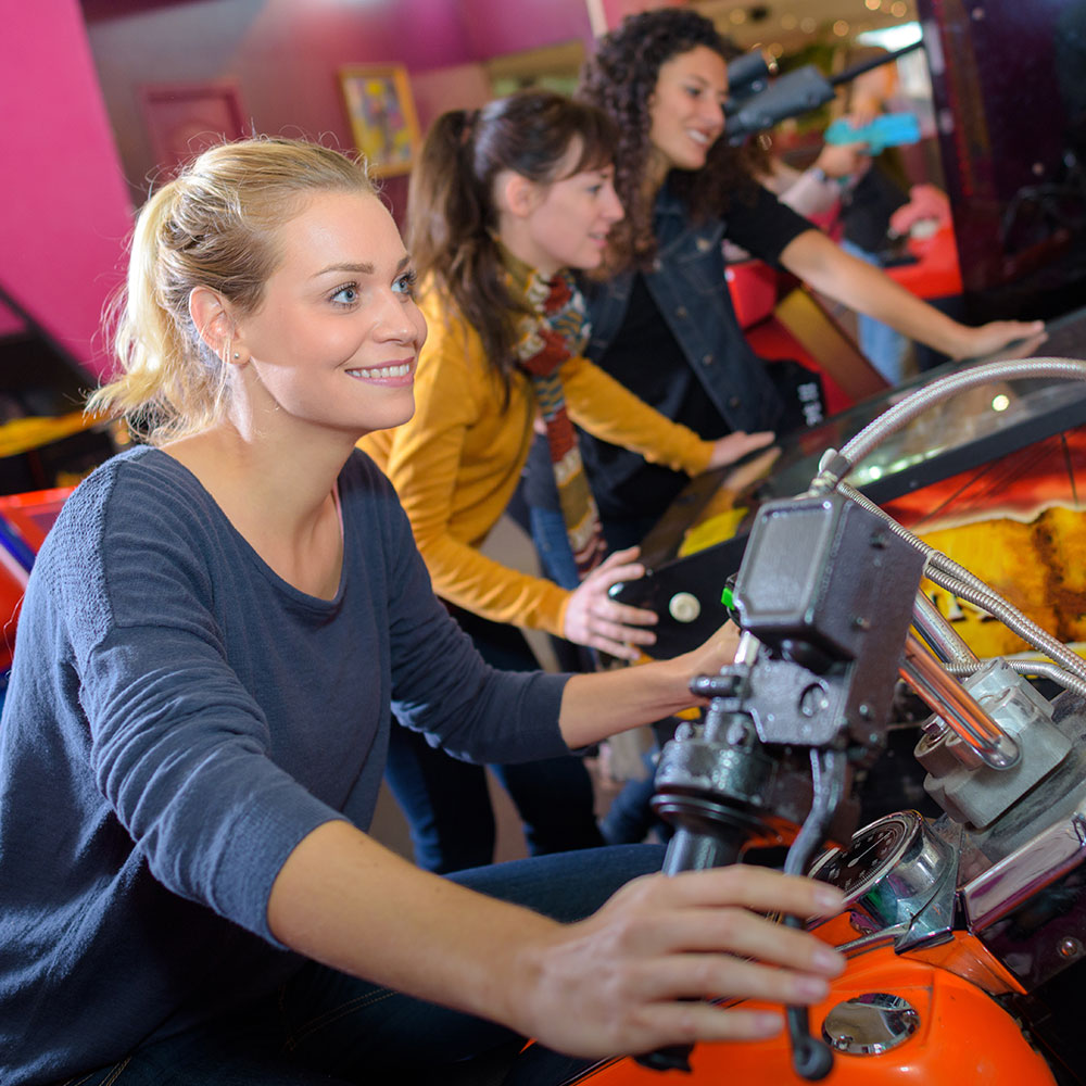 Young Adult Women Playing Arcade Games